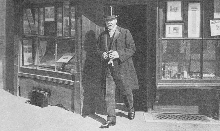 A photograph of Alfred Dickens leaving the shop.