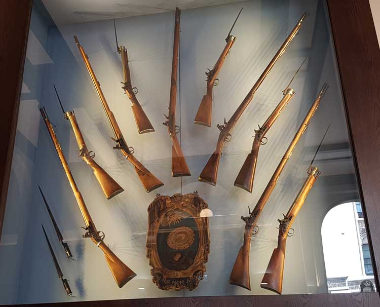 The guns in their glass case.