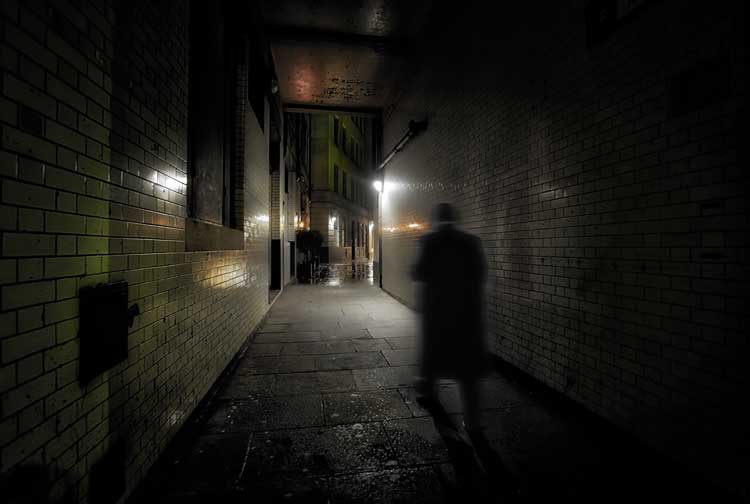 Richard Jones walking through an alleyway.