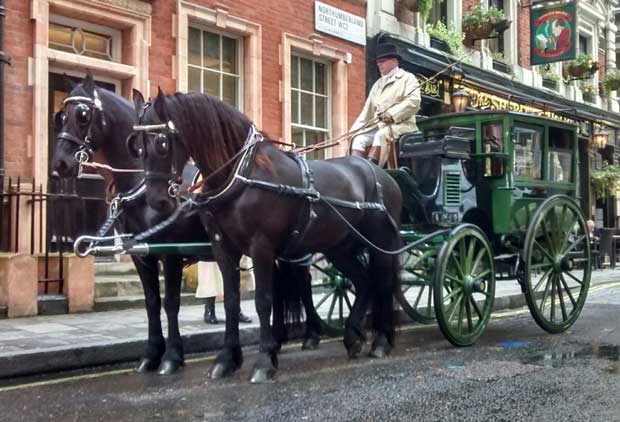 A horse drawn carriage outside the Sherlock Holmes pub in London.
