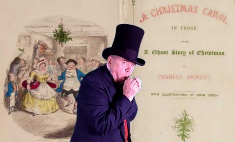Richard Jones in a top hat next to a copy of A Christmas Carol.