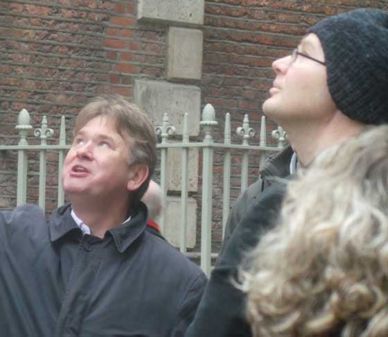 Richard Jones guiding a group of tour participants in the City of London. He is getting them to look up at a church tower.