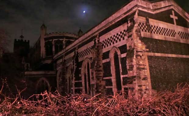 The Church of St Bartholomew The Great seen by night.