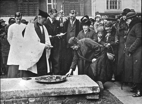 The widows sixpence charity being performed in St Bartholomew's churchyard on Good Friday.