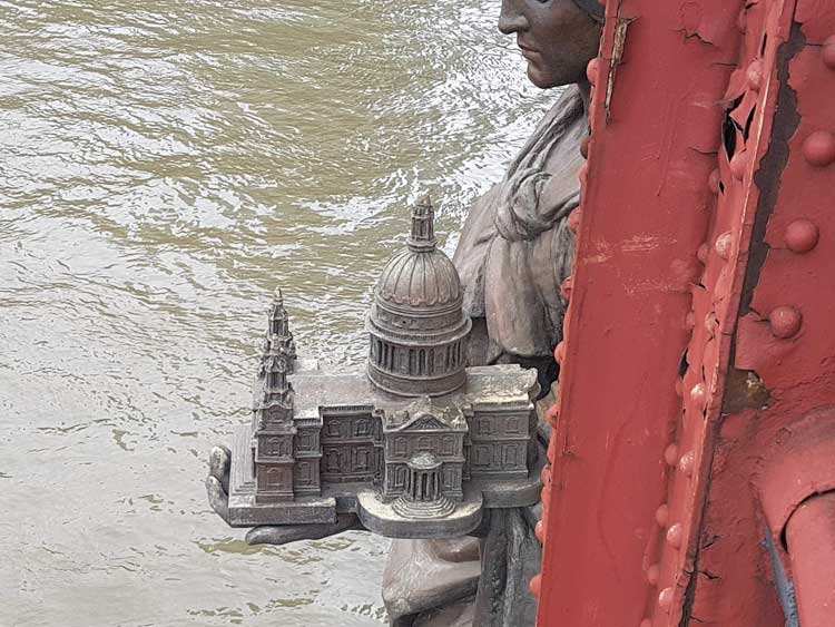 The statue of Architecture holding the miniature of St Paul's Cathedral.