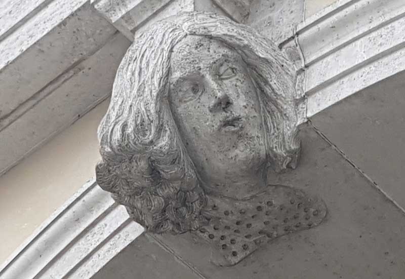 The second carved face that glances to the left