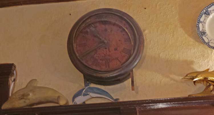 A view of the Dolphin clock hanging on the wall.