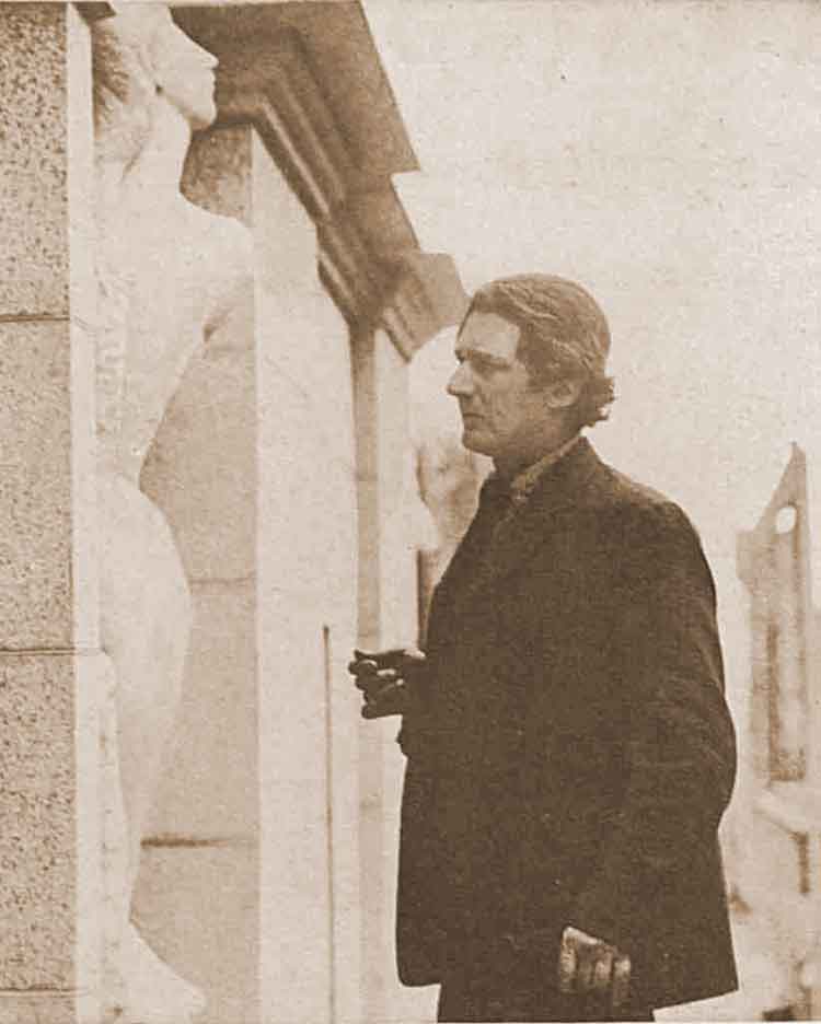 A photograph showing Jacob Epstein working on one of the statues.