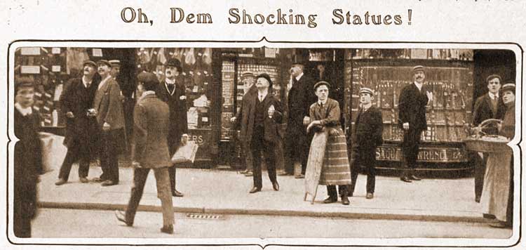 People look up at the statues.