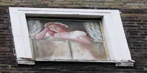 The girl in the nightdress who looks down from an upper window at the Newman Arms.